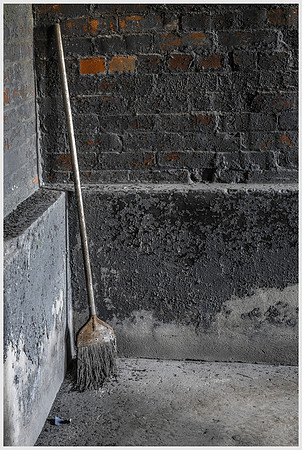 Leaning Broom Against Peeling Wall